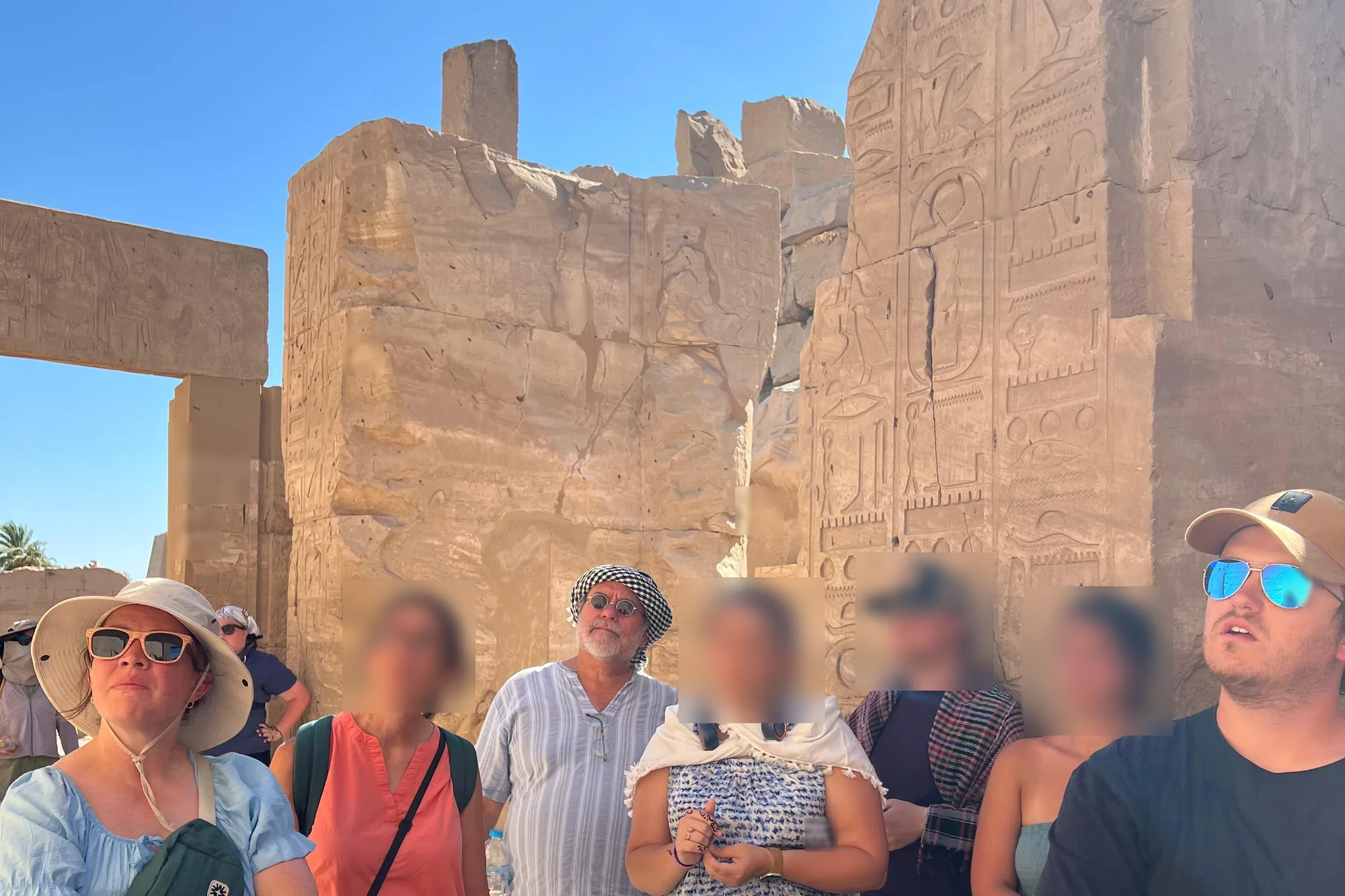 A Goshen guide with travellers at Karnak